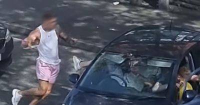 "What's wrong with people?!": Horrifying video shows fight breaking out on busy road as car appears to CIRCLE man... before driving RIGHT at him